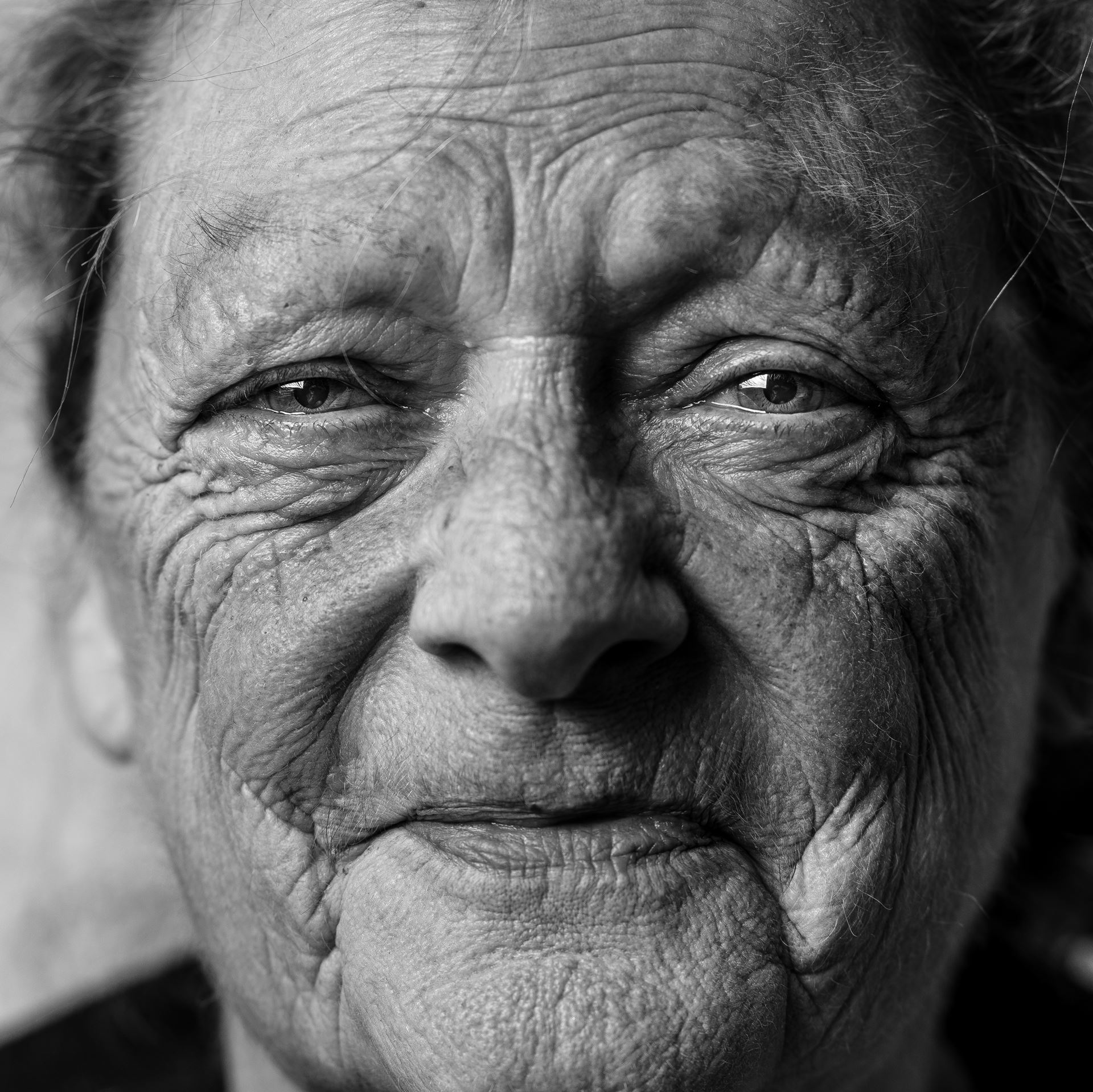 a close up of a man who is smiling and looking at the camera